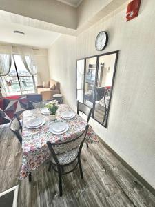 een kamer met een tafel en een klok aan de muur bij Dpto acogedor con terraza privada in Lima