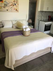 a bedroom with a large bed with a basket of towels at Thealassa in Kalliópi
