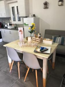 a dining room table with two chairs and a kitchen at Thealassa in Kalliópi