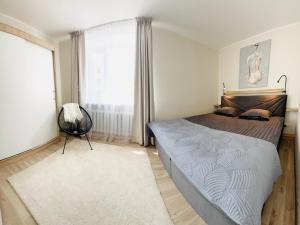 a bedroom with a large bed and a large window at Stylish apartment in Central City, near D-Terminal in Tallinn
