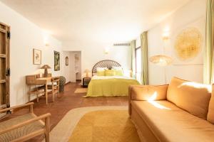a living room with a bed and a couch at Cortijo Genesis in Gaucín +61 photos