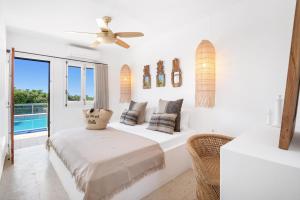 una stanza bianca con un letto e una finestra di Villa Bini Ezolea a Binibeca Altre 32 foto