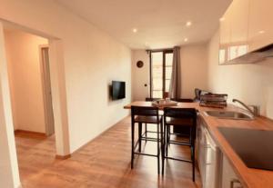 a kitchen with a counter and some bar stools at Tenuta San Lorenzo in Melazzo