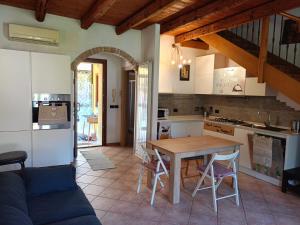 a kitchen and dining room with a table and chairs at Nina in Monfalcone