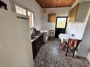 a kitchen with a refrigerator and a table in it at Home in Katakolo