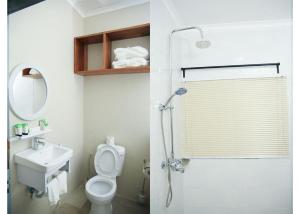 a bathroom with a shower and a toilet and a sink at The Dawn cottage in Moshi +44 photos