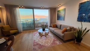 a living room with a couch and a table at רויאל שנגרילה in Eilat