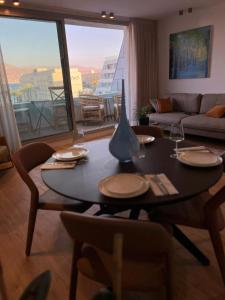 a living room with a table and a couch at רויאל שנגרילה in Eilat