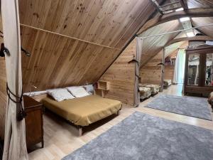 a bedroom with a bed in a wooden room at L'abri de rioumaou in Saligos