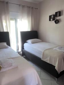 a bedroom with two beds and a window at Καλλιθεα in Kallithea Halkidikis
