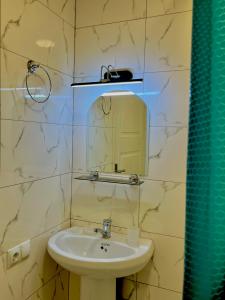 a bathroom with a sink and a mirror at Cozy-Corner Guesthouse in Mestia +41 photos