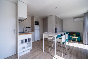 a kitchen and living room with a table and chairs at Am See 90 in Seekirchen am Wallersee