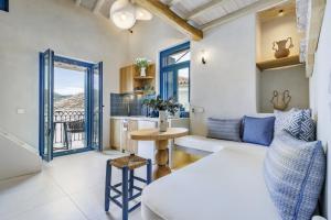 a living room with a bed and a table at Campanile Seaview Serenity in Skopelos Town