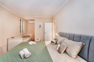 a room with a large bed with pillows on it at SAMM Apartments Šibenik in Šibenik +44 photos