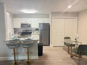 a kitchen with a stainless steel refrigerator and a table at Apartment in Houston near NRG with Free Parking in Houston