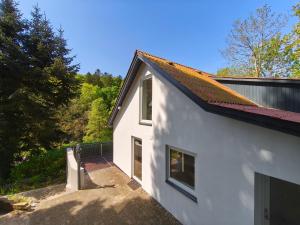 a white house with a roof and a staircase at Riverview Cottage in Randbøl