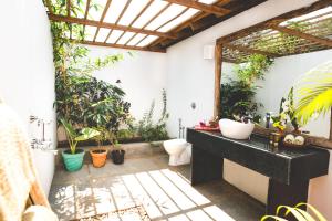 a bathroom with a sink and a bunch of plants at The Bay Agonda in Agonda