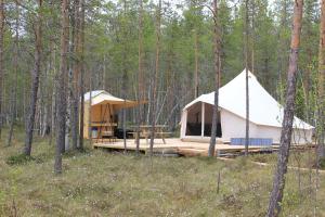 ÅseleVästerled Glamp的树林里的一个白色大帐篷