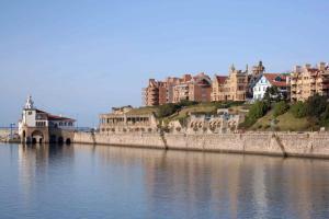 a group of buildings on the side of a river at Gure Toki Algorta cerca de la playa y de la ciudad in Getxo
