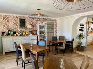 a kitchen and dining room with a table and chairs at Auberge du Relais d'Auniac - Hôtel Bar Restaurant Bistronomique Piscine in Anglars-Nozac