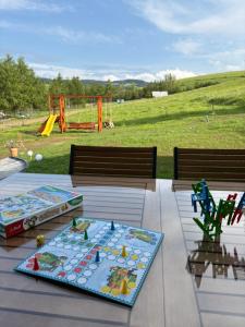 a picnic table with a play park in the background at Tam Gdzie Rosną Poziomki in Kacwin