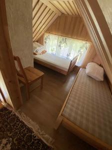 PadakõrveにあるKodavere puhkemaja 2のベッドと椅子付きの小さな屋根裏部屋です。