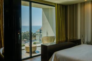 a bedroom with a bed and a view of the ocean at Vila Foz Hotel & SPA - member of Design Hotels in Porto +37 photos