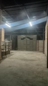 an empty garage with a large room with stalls at Домашний уют in Akchiy +2 photos