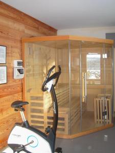 a scooter is in a room with a glass wall at Panoramic Hill - Mountain View, Pool & Sauna in Berest +22 photos