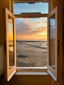 an open window with a view of the beach at No 42 by GuestHouse, Margate in Margate