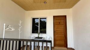 a room with a table and a window and a door at Felomina Guesthouse in San Juan