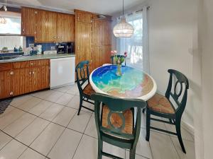 a kitchen with a table with a vase on it at The CrabTrap at Flagler Beach - Unit A in Flagler Beach +57 photos