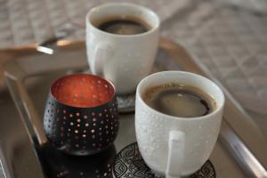 a tray with three cups of coffee on it at Villa Tzekos in Epanomi