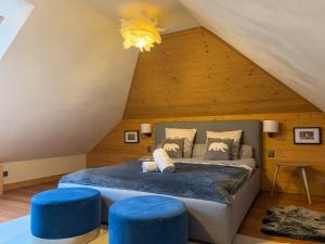 a bedroom with a bed with blue stools at Panoramic Hill - Mountain View, Pool & Sauna in Berest