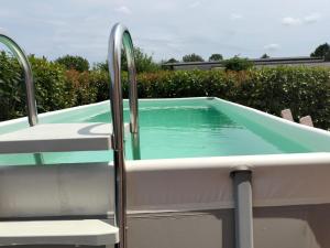 a swimming pool with two chairs next to it at Al giardino nascosto in Visco
