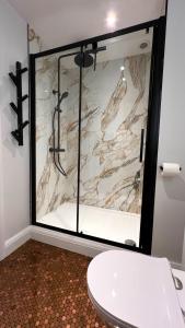 a bathroom with a window with a white toilet at The Simms Suite in Worthing +13 photos