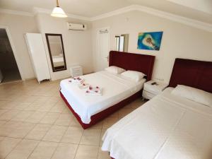A bed or beds in a room at Bucak Apart Hotel Göcek & Beach
