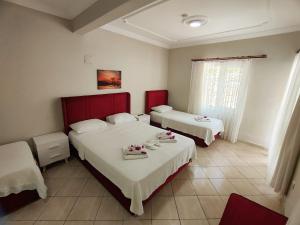 A bed or beds in a room at Bucak Apart Hotel Göcek & Beach