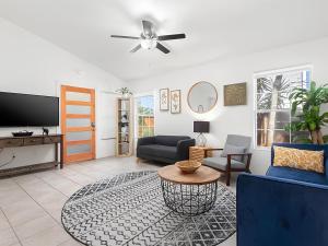 a living room with a couch and a tv at Anastasia Island Villa Upper Level plus Rooftop in St. Augustine