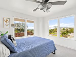 a bedroom with a bed and a ceiling fan at Anastasia Island Villa Upper Level plus Rooftop in St. Augustine