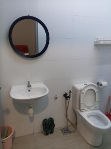 a bathroom with a sink and a toilet and a mirror at Family Studio Homestay Core Soho Kip Sentral Near KLIA & KLIA2 in Sepang +21 photos