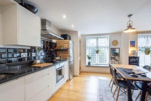 a kitchen with a table and a dining room at Modern Apartment, Frome, WiFi, Double Bed, Smart TV in Frome