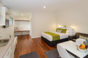 a bedroom with a bed and a living room at Margaret River Beach Studios in Margaret River Town