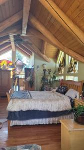 a bedroom with a large bed in a room with wooden ceilings at My Dream Home in Mount Shasta