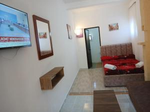 a living room with a couch and a tv on a wall at Gini Palace - Shengjin in Shëngjin +37 photos