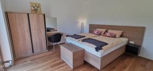 une chambre avec un lit avec une tête de lit en bois dans l'établissement Apartment Ratek, à Ivanjkovci