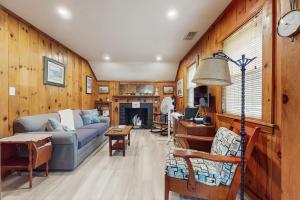 a living room with a couch and a fireplace at Uncle Rolfs Cozy Cottage in Dennis Port