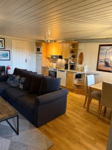 a living room with a couch and a kitchen at Åskollen, Drammen in Drammen