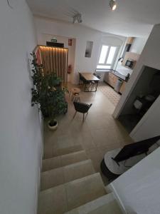 a living room with a staircase with a table and chairs at Apartamento Aftasi ,excelente ubicación con parking publico a 20 m in Badajoz