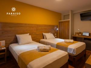 Cama o camas de una habitación en Hoteles Paraiso CHICLAYO